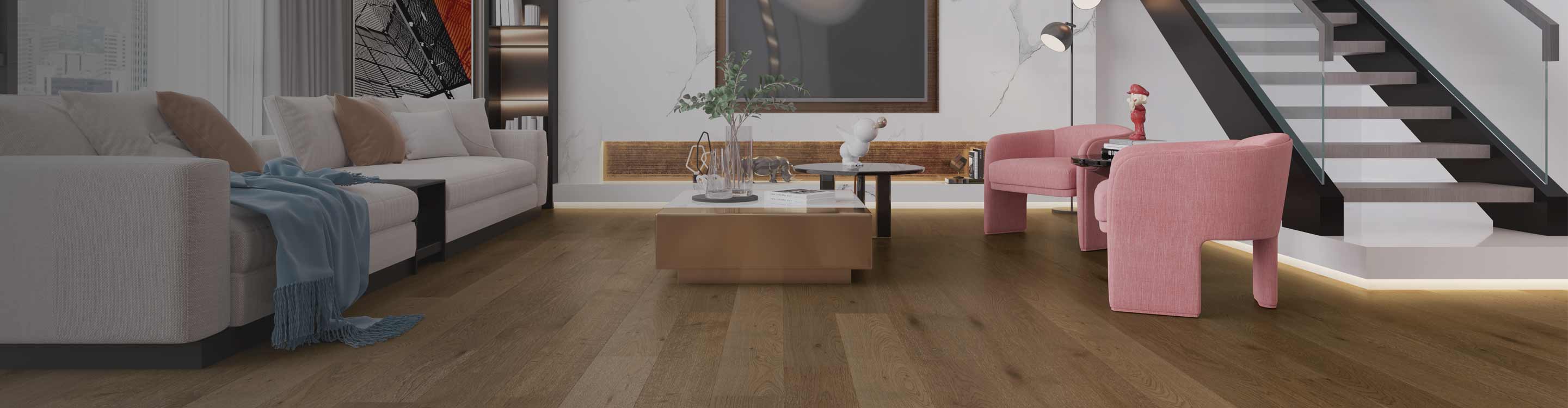 Expert hardwood installation featuring wide-plank medium-brown oak floors in a luxury living room with contemporary furniture, a marble wall, and a modern staircase.
