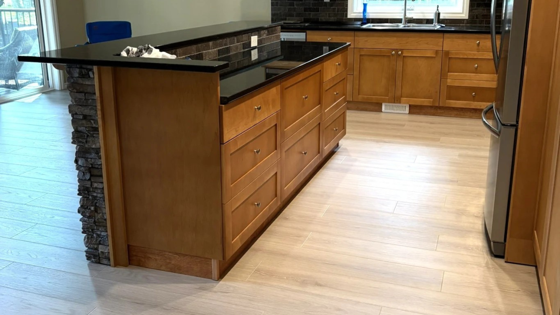 Light wood luxury vinyl flooring installation in Chilliwack BC kitchen